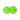 Two green golf balls rest on a white background.