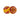 Two plastic marbles with tie-dye patterns roll on a white surface.